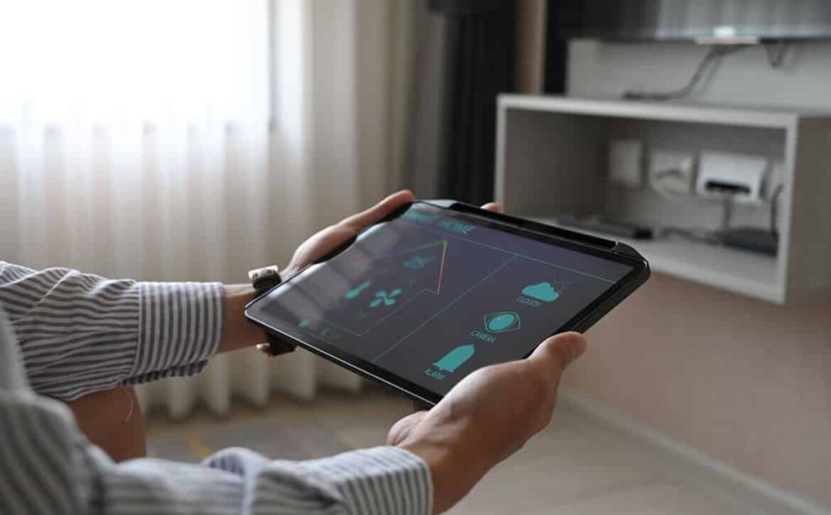 Cropped image hands are using a tablet with home devices control