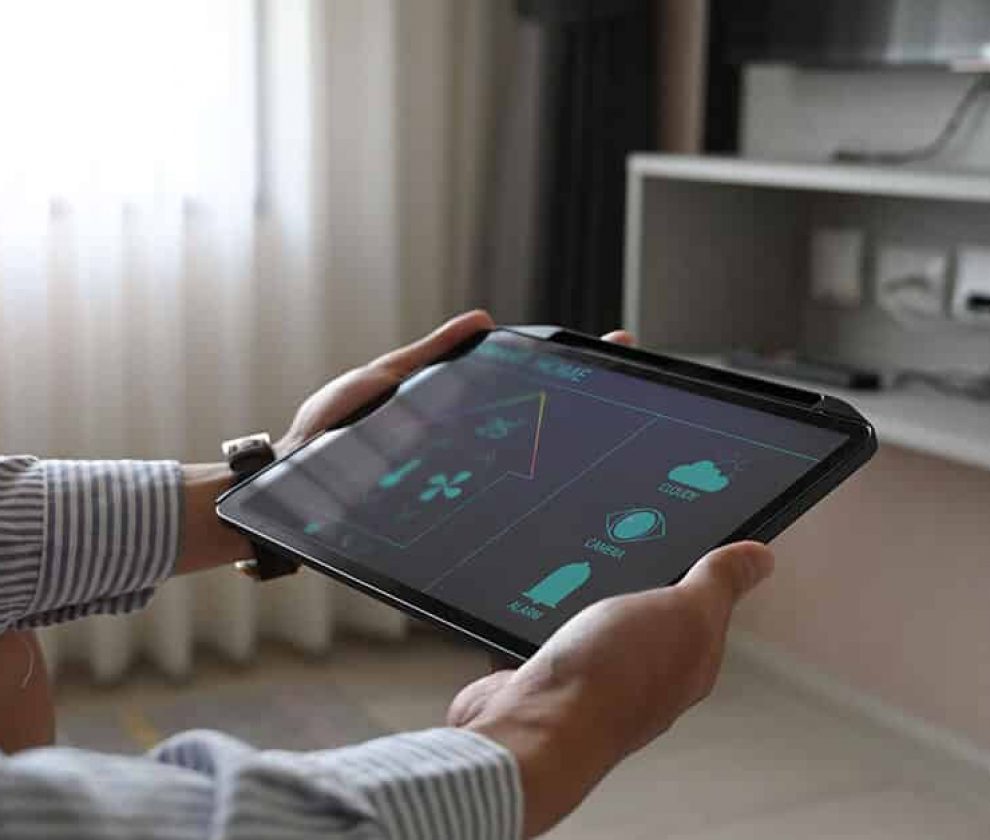 Cropped image hands are using a tablet with home devices control