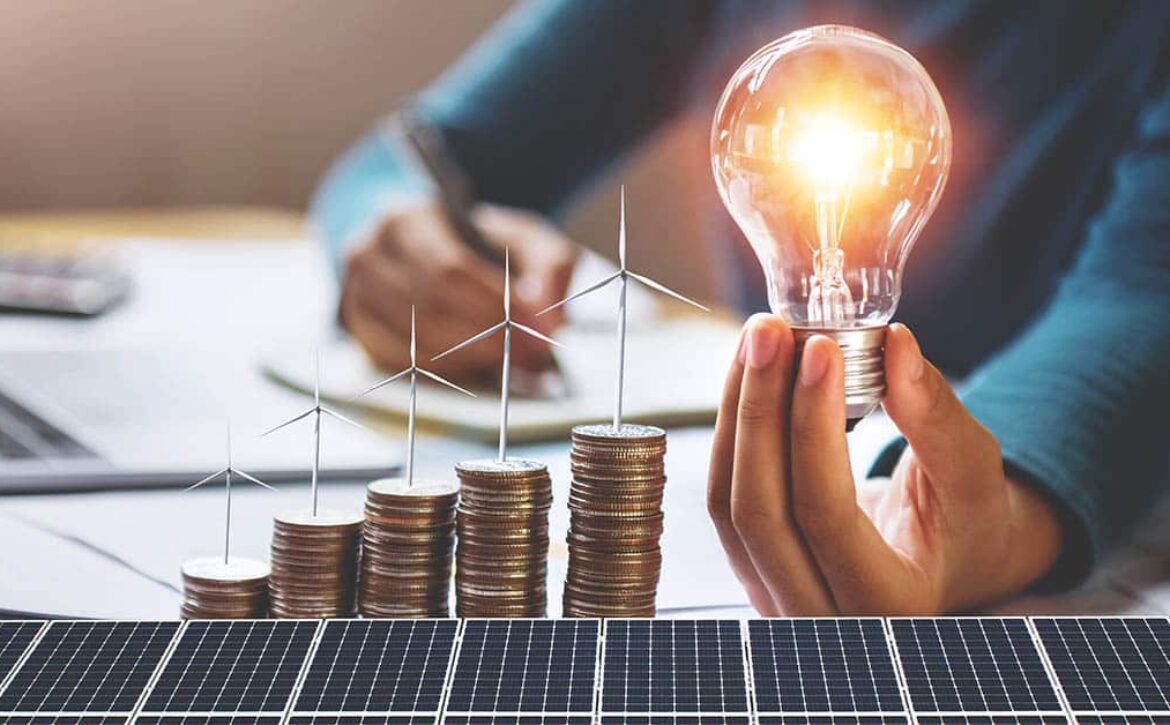 businesswoman holding light bulb with turbine on coins and solar